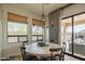 Dining room with a modern chandelier, large windows, and sliding glass door access to outdoor living area at 1904 N Steele --, Mesa, AZ 85207