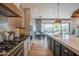 Modern kitchen with granite countertops, custom cabinetry, and a chef-grade gas range at 1904 N Steele --, Mesa, AZ 85207