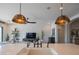 Close-up of kitchen island with pendant lights, sink, and view into living space at 1904 N Steele --, Mesa, AZ 85207