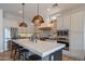 Well-lit modern kitchen with black countertops, white cabinets, and stainless steel appliances at 1904 N Steele --, Mesa, AZ 85207