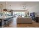 Open-concept kitchen and living area with a large island and sliding glass doors to the patio at 1904 N Steele --, Mesa, AZ 85207