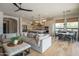 Open-concept living room featuring comfortable seating, a modern kitchen, and adjacent dining area at 1904 N Steele --, Mesa, AZ 85207
