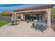 Inviting covered patio with travertine tile, ceiling fan, and outdoor furniture perfect for relaxing at 1904 N Steele --, Mesa, AZ 85207
