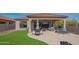 Relaxing covered patio with ample seating, artificial turf, and low-maintenance desert landscaping at 1904 N Steele --, Mesa, AZ 85207