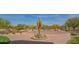 Community entrance roundabout with mature desert landscaping at 1904 N Steele --, Mesa, AZ 85207