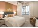 Bright bedroom features stylish decor, a modern lamp, and a large window, creating a cozy and inviting space at 19045 W Rose Ln, Waddell, AZ 85355