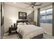 Well-lit bedroom features stylish decor and a ceiling fan for added comfort; large window provides lots of natural light at 19045 W Rose Ln, Waddell, AZ 85355