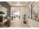 Bright hallway showcasing elegant decor, tile flooring, and access to the living space at 19045 W Rose Ln, Waddell, AZ 85355