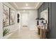 Elegant hallway featuring tile flooring, decorative lighting, and stylish wall decor at 19045 W Rose Ln, Waddell, AZ 85355