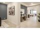 Inviting hallway featuring stylish decor, neutral tones, and views into the living area at 19045 W Rose Ln, Waddell, AZ 85355