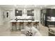 Modern kitchen with a large central island, bar stool seating, and stainless steel appliances at 19045 W Rose Ln, Waddell, AZ 85355