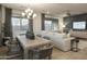 The dining area is open to the living room, creating a spacious and inviting atmosphere at 19045 W Rose Ln, Waddell, AZ 85355