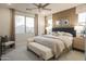 Serene main bedroom with neutral tones, comfortable seating, and abundant natural light at 19045 W Rose Ln, Waddell, AZ 85355