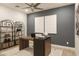 Modern home office with ample workspace, stylish decor, and a comfortable seating area at 19045 W Rose Ln, Waddell, AZ 85355