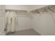 Bright walk-in closet features wood shelving for ample storage space and includes 2 plush, white robes at 19045 W Rose Ln, Waddell, AZ 85355