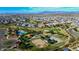 Scenic aerial view of a Primary-planned community featuring a pool, playground, and lush green spaces at 21617 S 229Th Way, Queen Creek, AZ 85142