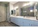 Bright bathroom with double vanity, framed mirrors and tiled floors at 21617 S 229Th Way, Queen Creek, AZ 85142
