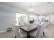 Dining area with sophisticated chairs, contemporary light fixture, and open to living spaces at 21617 S 229Th Way, Queen Creek, AZ 85142
