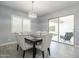 Elegant dining room with stylish chairs, modern lighting, and sliding doors to the outdoor area at 21617 S 229Th Way, Queen Creek, AZ 85142