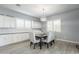 Cozy dining area featuring white cabinetry, modern light fixture, and ample natural light at 21617 S 229Th Way, Queen Creek, AZ 85142