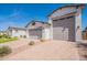 Charming home with a two-car garage and inviting landscaping, blending style with practicality at 21617 S 229Th Way, Queen Creek, AZ 85142