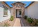 Charming front entrance with stone accents and professionally landscaped front yard at 21617 S 229Th Way, Queen Creek, AZ 85142