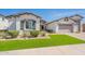 Attractive single-story home with stone accents, three-car garage, and artificial grass at 21617 S 229Th Way, Queen Creek, AZ 85142