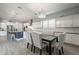 Spacious eat-in kitchen features white cabinetry, stainless appliances, and wood-style tile flooring at 21617 S 229Th Way, Queen Creek, AZ 85142