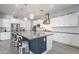 Modern kitchen with stainless appliances, a large island with seating, and ample counter space at 21617 S 229Th Way, Queen Creek, AZ 85142