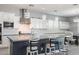 Bright kitchen with white cabinetry, a large island with seating, and modern pendant lighting at 21617 S 229Th Way, Queen Creek, AZ 85142