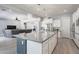 Modern kitchen with a large center island, stainless steel appliances, and open to the living area at 21617 S 229Th Way, Queen Creek, AZ 85142