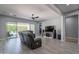 Spacious living room with tile floors, comfortable seating, and a large sliding door to the backyard at 21617 S 229Th Way, Queen Creek, AZ 85142