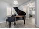Living room boasts a grand piano, neutral color scheme, and abundant natural light at 21617 S 229Th Way, Queen Creek, AZ 85142