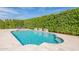 Beautiful pool featuring stone waterfalls and lush green hedges, creating a private backyard oasis at 21617 S 229Th Way, Queen Creek, AZ 85142