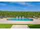 Lush backyard oasis features a pristine pool, manicured hedges, and comfortable lounge seating at 21617 S 229Th Way, Queen Creek, AZ 85142