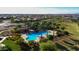 Aerial view of a community pool area with palm trees, lounge chairs, and a covered pavilion at 21617 S 229Th Way, Queen Creek, AZ 85142