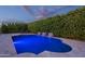 Backyard pool with water features, lounge chairs, turf and a privacy hedge at 21617 S 229Th Way, Queen Creek, AZ 85142