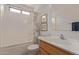 Bright bathroom with a shower-tub combo and wood vanity at 22300 N Kingston Dr, Maricopa, AZ 85138