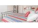 Cozy bedroom showcasing striped bedding and a comfortable aesthetic at 22300 N Kingston Dr, Maricopa, AZ 85138