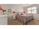 Bright bedroom with a black metal bed frame, striped bedding, and neutral-toned walls at 22300 N Kingston Dr, Maricopa, AZ 85138
