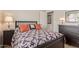 Inviting bedroom featuring dark wood furniture and a patterned bedspread at 22300 N Kingston Dr, Maricopa, AZ 85138