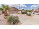Single-story home featuring a two-car garage, desert landscaping and large driveway at 22300 N Kingston Dr, Maricopa, AZ 85138