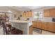 Open kitchen with breakfast bar, bright dining area and view to backyard at 22300 N Kingston Dr, Maricopa, AZ 85138