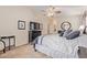 Bright main bedroom with ceiling fan and a bed with stylish patterned bedding at 22300 N Kingston Dr, Maricopa, AZ 85138