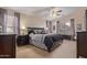 Comfortable main bedroom featuring plush bedding, a ceiling fan, and neutral-toned walls at 22300 N Kingston Dr, Maricopa, AZ 85138