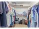 Spacious walk-in closet offering ample storage space for clothes and accessories at 22300 N Kingston Dr, Maricopa, AZ 85138