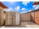 View of the backyard of the property with a storage shed and block wall at 2331 W Hartford Ave, Phoenix, AZ 85023