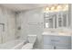 Beautiful bathroom featuring nice tile, vanity, sink, tub, shower, and lighting at 2331 W Hartford Ave, Phoenix, AZ 85023