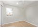 A bright bedroom with a ceiling fan and natural light streaming through the window at 2331 W Hartford Ave, Phoenix, AZ 85023