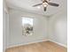 Bright bedroom featuring neutral walls, light floors, white door, and a window at 2331 W Hartford Ave, Phoenix, AZ 85023